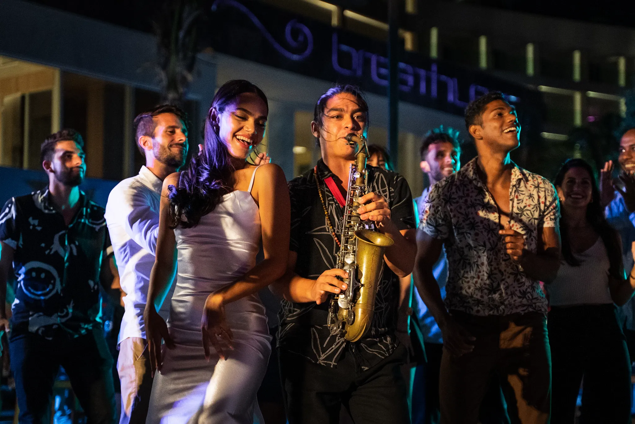 Guests dancing to live saxophone music at Breathless Cancun Soul Resort nightlife event.