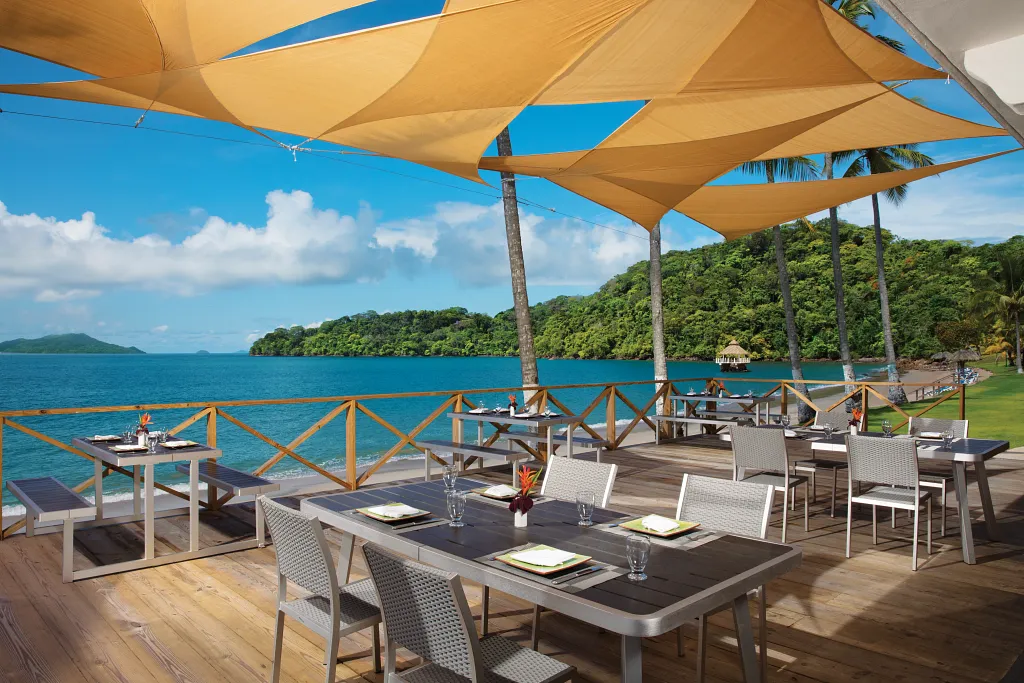 Barefoot Grill at Dreams Playa Bonita Panama featuring an oceanfront deck, shaded outdoor seating, and casual lunch dining by the sea.
