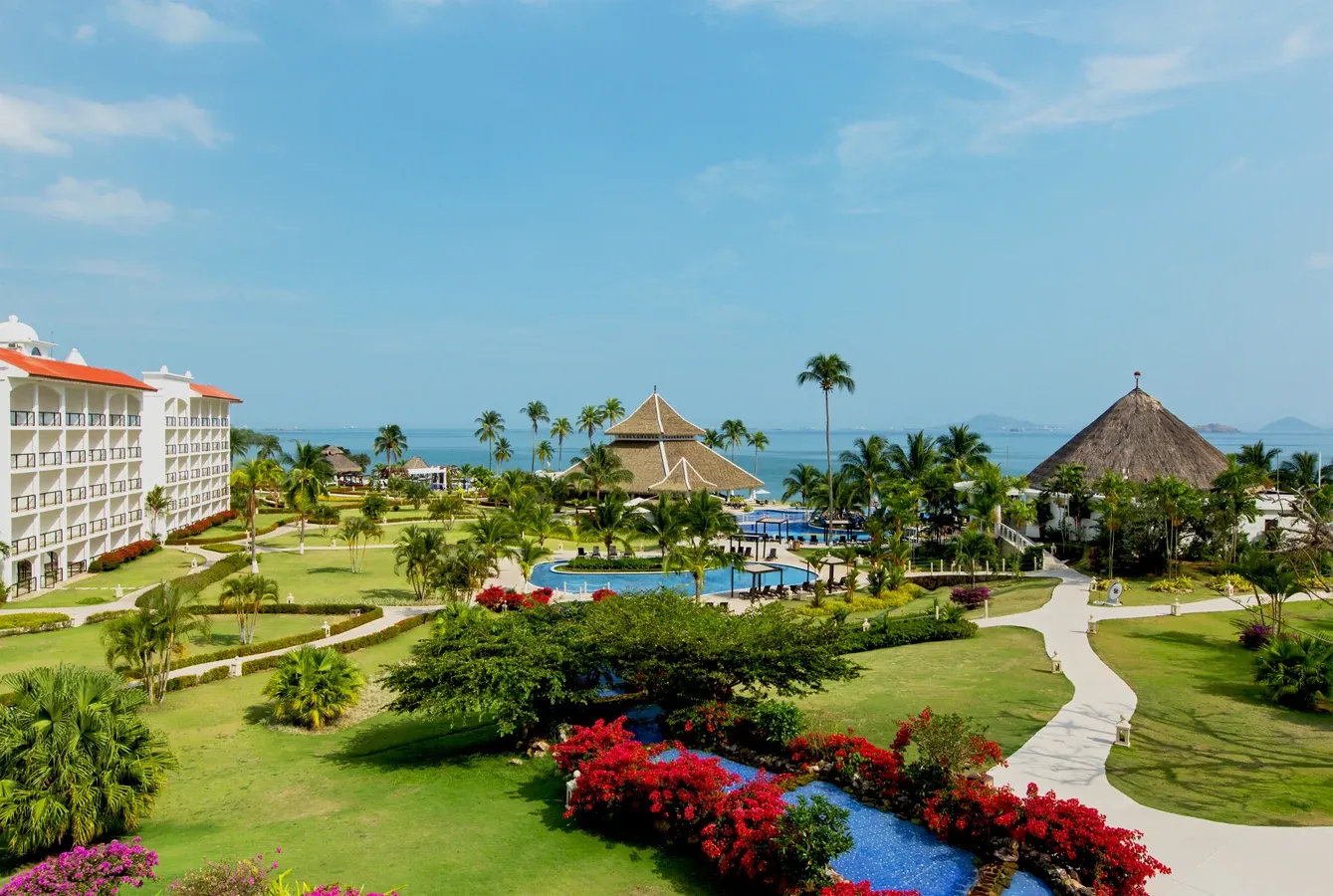 Daytime view of the tropical gardens, pools, and beachfront at Dreams Playa Bonita Panama, set along Panama’s Pacific coastline.