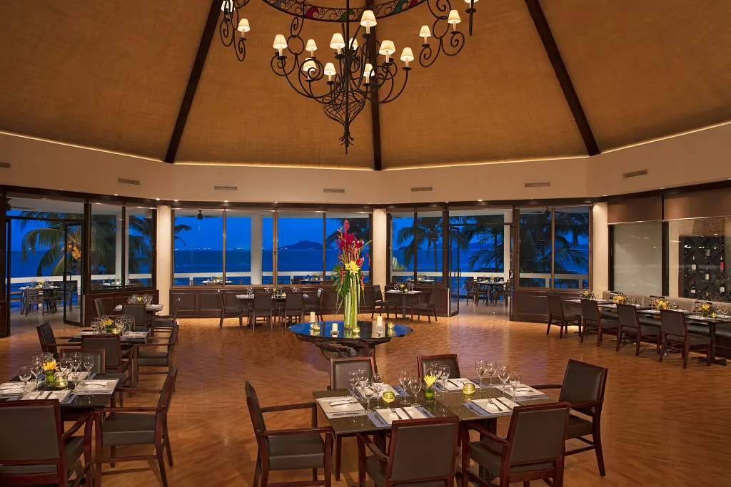 Oceana restaurant at Dreams Playa Bonita Panama featuring elegant ocean-view dining, warm lighting, and gourmet seafood tableside settings.