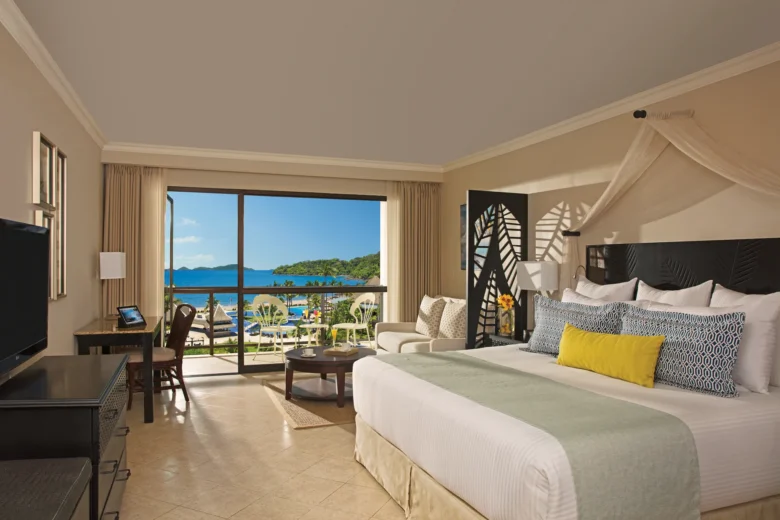 Preferred Club Deluxe Ocean View room with king bed and private balcony at Dreams Playa Bonita Panama overlooking the ocean.
