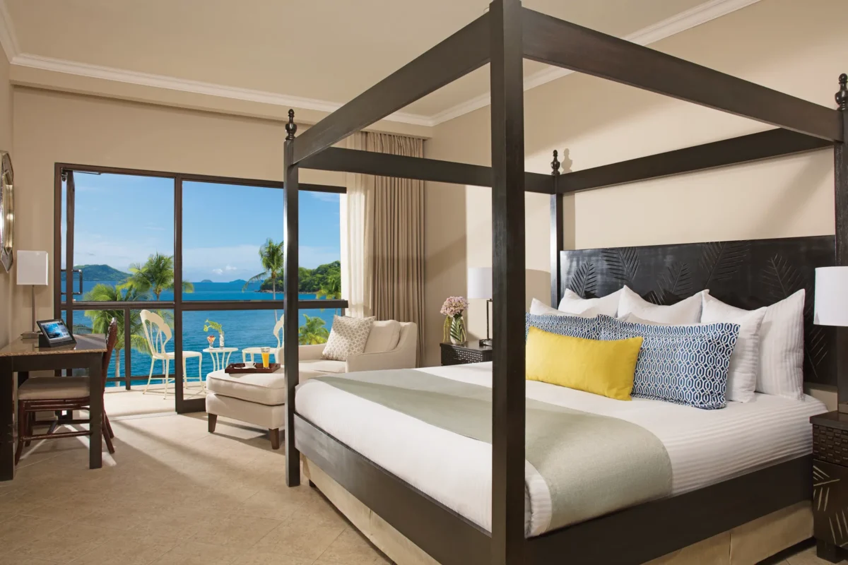Preferred Club Junior Suite Ocean View bedroom with king bed at Dreams Playa Bonita Panama.